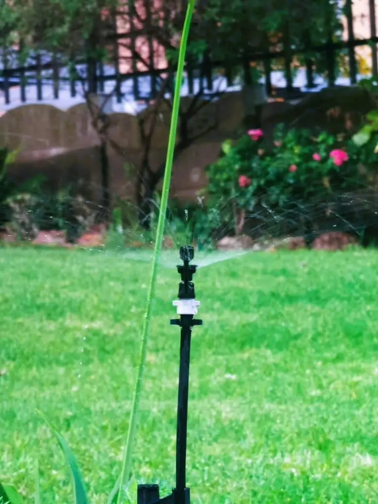 lawn sprinkler operating on a green grass lawn automatic irrigation